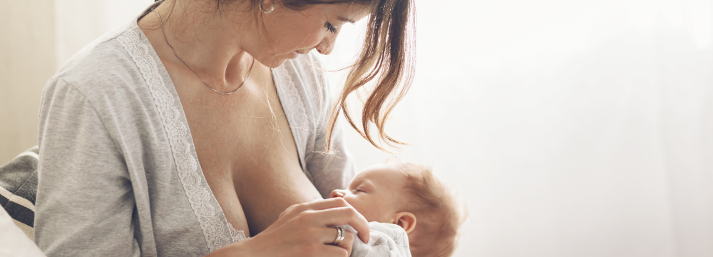 Woman Breast Feeding after Breast Enhancement Surgery