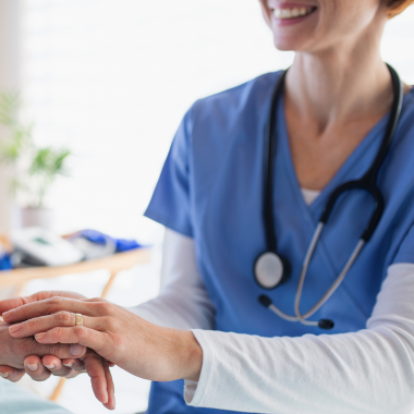 Woman being comforted by a nurse following Breast Augmentation Gold Coast