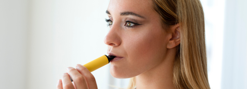 Woman Vaping an e cigarette before her surgery