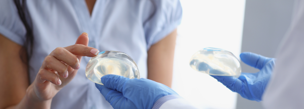 Woman comparing the benefits of a Silicone Breast Implant with a Saline Breast Implant ahead of a Breast Enhancement Surgery Gold Coast