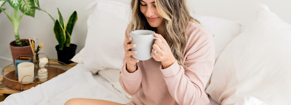 Woman drinking a cup of tea after Breast Enhancement Surgery