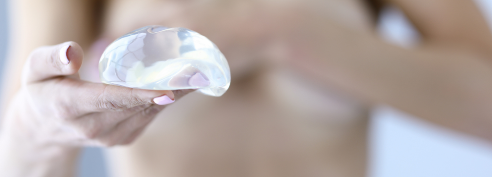 Woman contemplating Breast Augmentation costs, a procedure also known as a Boob Job